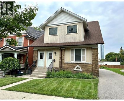 A two-story house with a front porch and a garage door.
