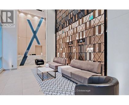 A modern living room with a large X-shaped decoration on the wall.