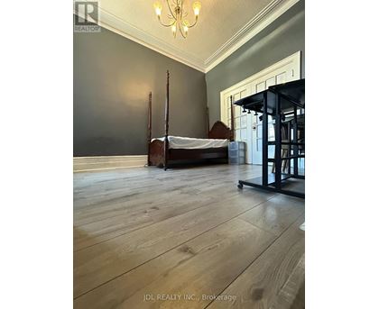 A bedroom with a bed and a chair.