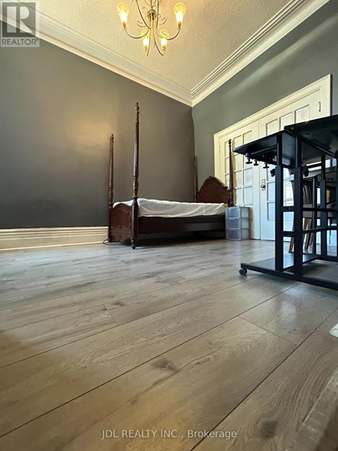A bedroom with a bed and a chair.