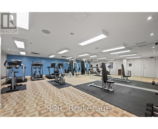 A gym with a variety of equipment including treadmills, weights, and exercise machines.