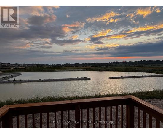 A view from a balcony overlooking a body of water with a sunset sky.