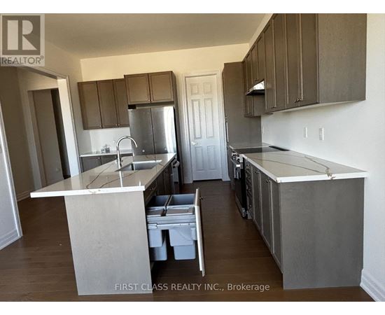 A kitchen with a white counter top and brown cabinets.