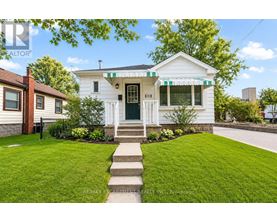 A white house with a green door and a small porch.
