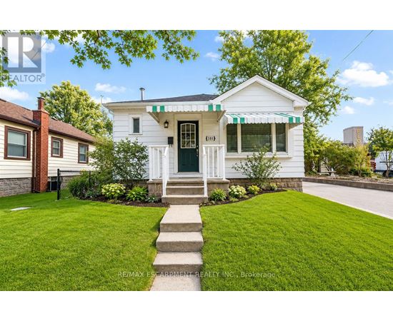 A white house with a green door and a small porch.