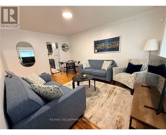 A living room with a grey couch and a small table.
