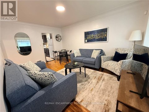 A living room with a grey couch and a small table.
