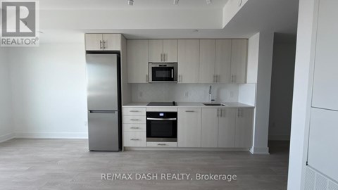 A kitchen with white cabinets and appliances is for sale.