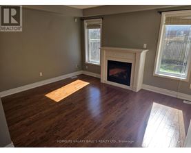 A room with a fireplace and wooden floors.