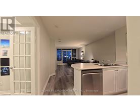 A modern kitchen with white cabinets and a central island.