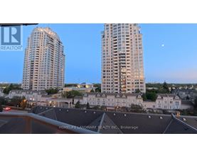 Two high-rise buildings are seen in the distance with a moon in the sky.