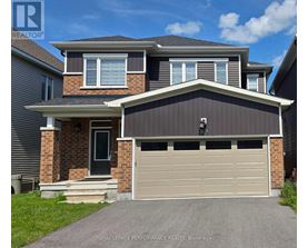 A two-story house with a garage door is for sale.