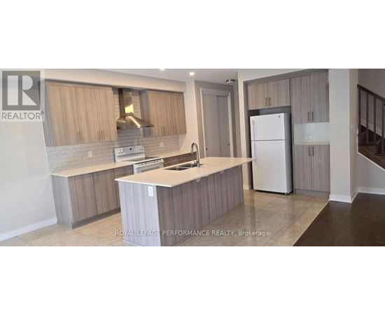 A kitchen with a white countertop and wooden cabinets.