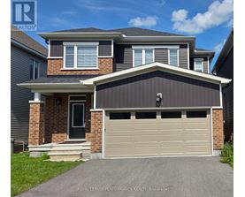 A two-story house with a garage is for sale.