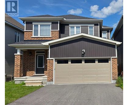 A two-story house with a garage is for sale.