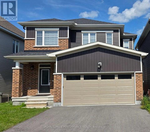 A two-story house with a garage is for sale.