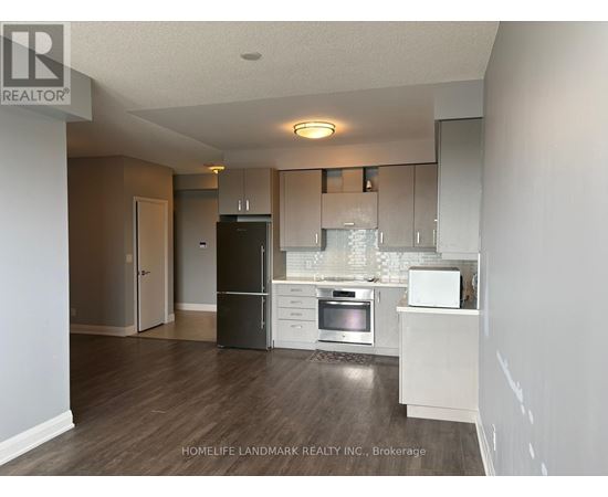 A kitchen with a black fridge, white dishwasher, and a white oven.