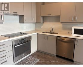 A kitchen with a stove top oven, microwave, and dishwasher.