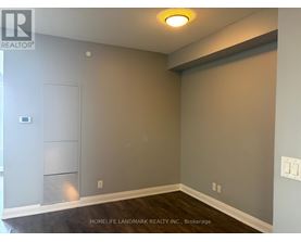 A room with a grey wall and a white door.