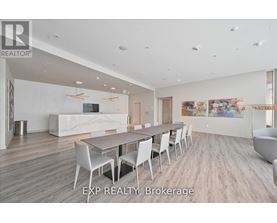 A large, modern dining room with a long table and chairs.