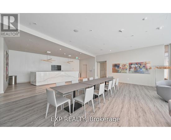 A large, modern dining room with a long table and chairs.