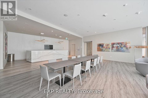 A large, modern dining room with a long table and chairs.