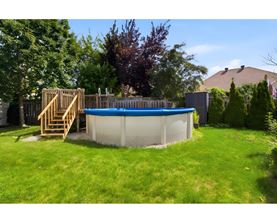 A small above ground pool with a wooden staircase.