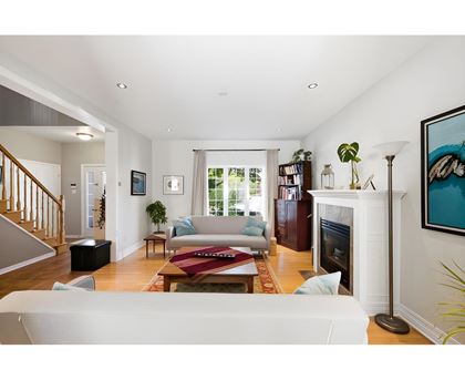 A living room with a fireplace and a painting on the wall.