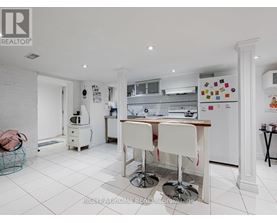 A white kitchen with a table and chairs.