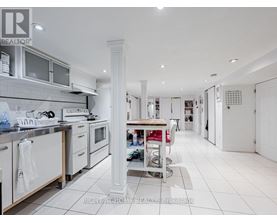 A white kitchen with a large island in the middle.