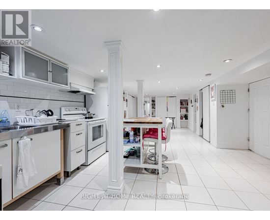 A white kitchen with a large island in the middle.