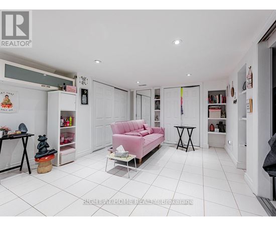 A living room with a pink sofa and a small table.