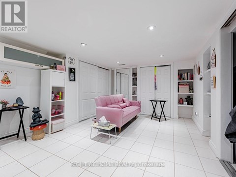 A living room with a pink sofa and a small table.