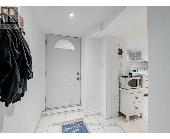 A white door is in a hallway with a sign on the floor.