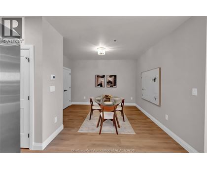 A dining room with a table set for two.