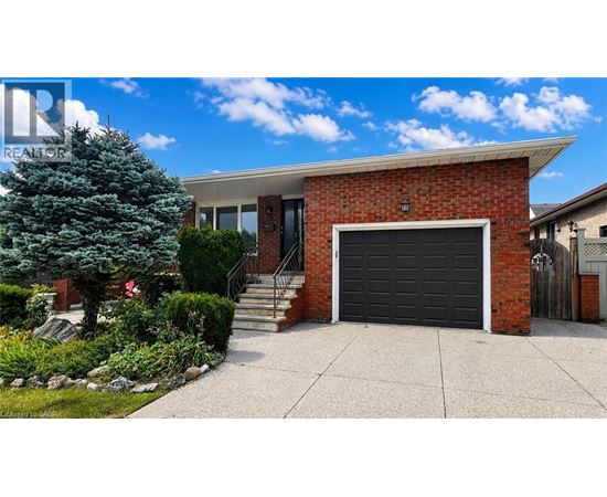 A house with a red brick exterior and a black garage door.