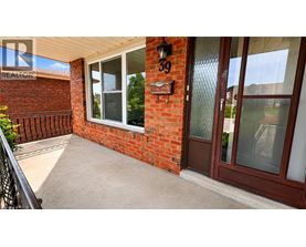 A red brick house with a glass door and a window.