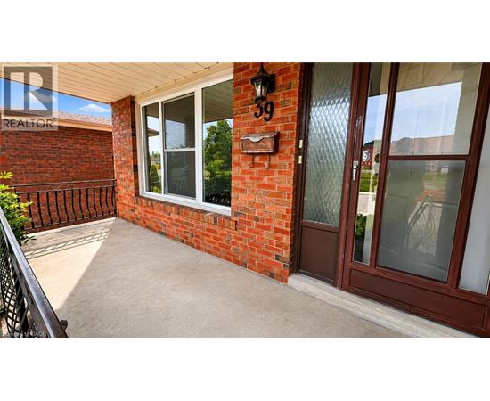 A red brick house with a glass door and a window.