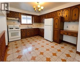 A kitchen with brown cabinets and a white refrigerator.