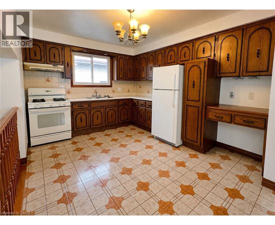 A kitchen with brown cabinets and a white refrigerator.