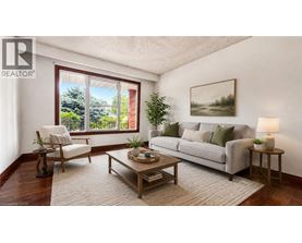 A living room with a couch, chair, and a table with a lamp on it.