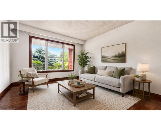 A living room with a couch, chair, and a table with a lamp on it.