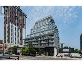 A modern building with a glass facade is under construction in the foreground.