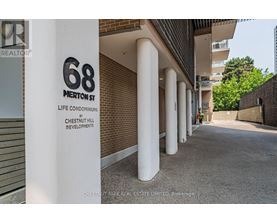 A sign for 68 Merritt Street stands in front of a building.
