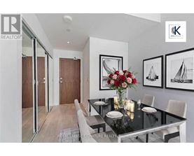 A dining room with a glass table and chairs.