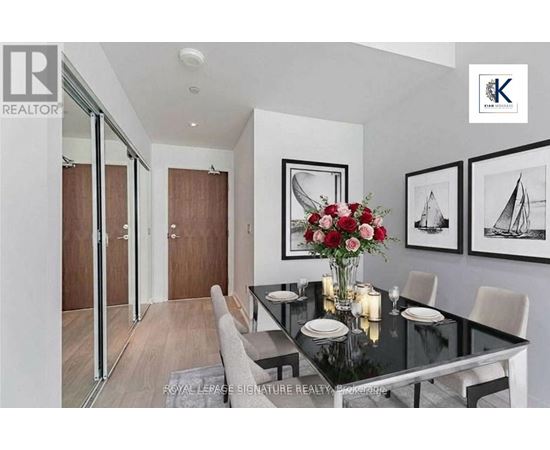 A dining room with a glass table and chairs.