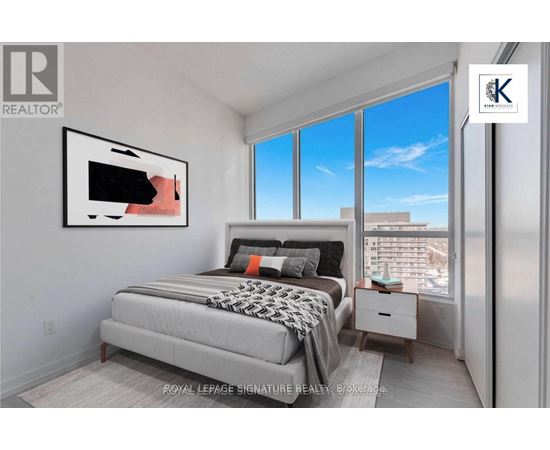 A bedroom with a large bed and a painting on the wall.
