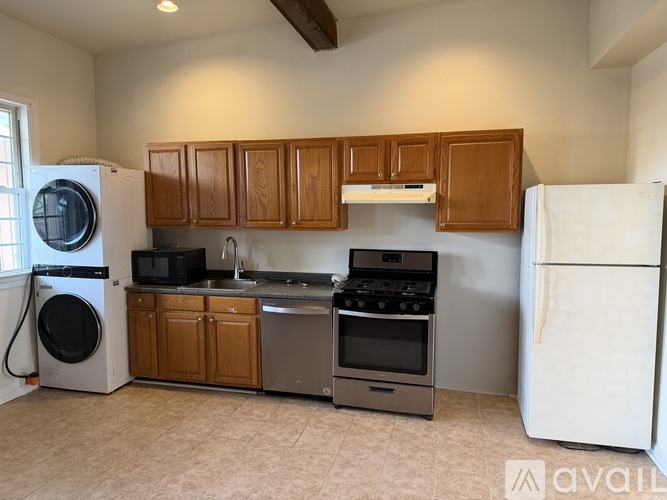 A kitchen with wooden cabinets and a white refrigerator.