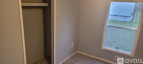A room with a window and a door.