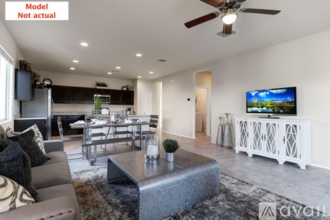 A living room with a television on the wall and a couch.